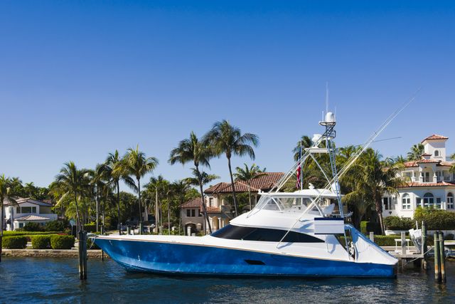 Side-shot of yacht in front of houses