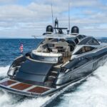 Luxury motor yacht cruising at speed on open water.